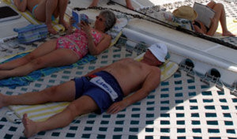 65 Woodwind Kurt Hughes Custom Catamaran Relaxing on Forward Tramps