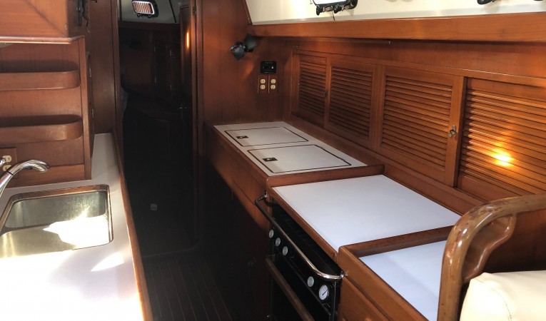 48 Tayana Long galley with lots of counter space and storage cabinets and lockers